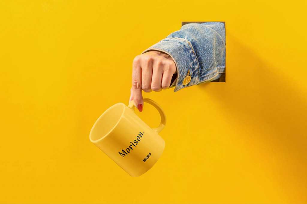 Cup with Hand Mockup designe